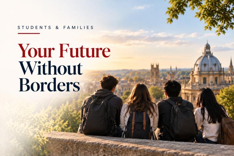 Four students with backpacks, seen from behind, sitting on a wall overlooking a city skyline at sunset